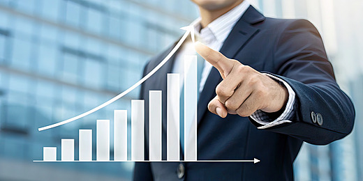 pngtree-businessman-holding-a-rising-graph-and-arrow-an-upward-growth-concept-image_17237289